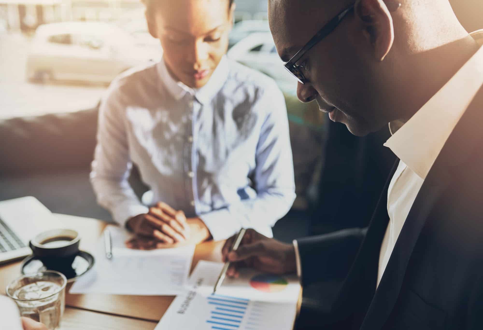 Two black business people discussing their business